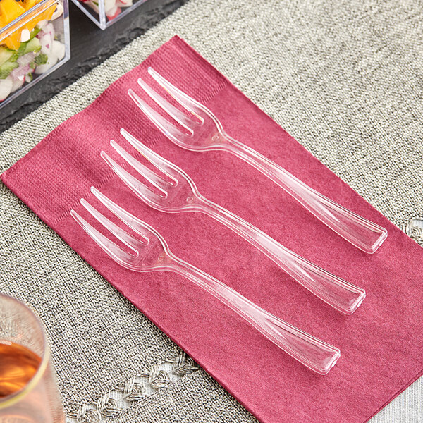A group of Visions clear plastic tasting forks on a napkin.