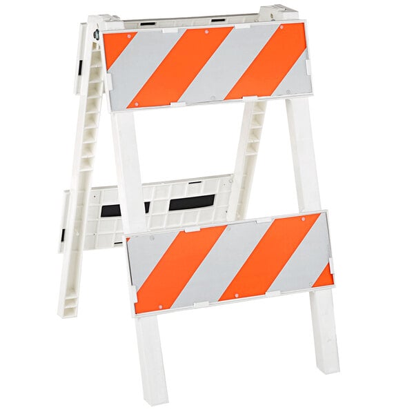 A white and orange Cortina Plastx engineer grade reflective barricade with white and orange stripes.