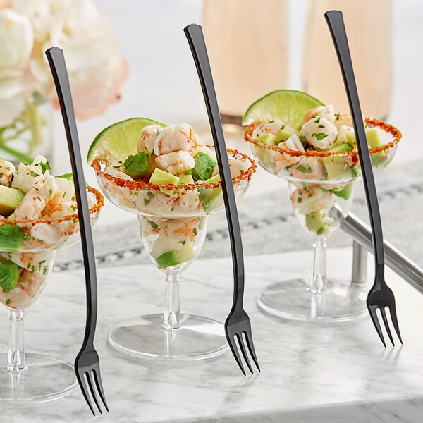 A Visions black plastic tasting fork in a glass of shrimp.