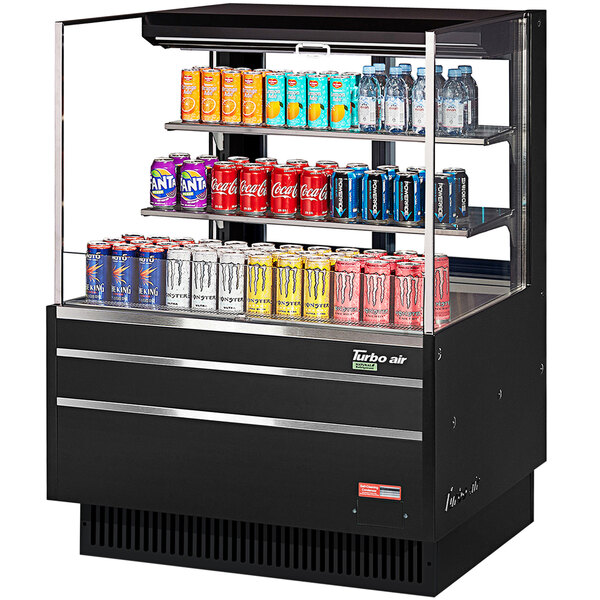A black Turbo Air horizontal refrigerated open curtain merchandiser with drinks and cans on shelves.
