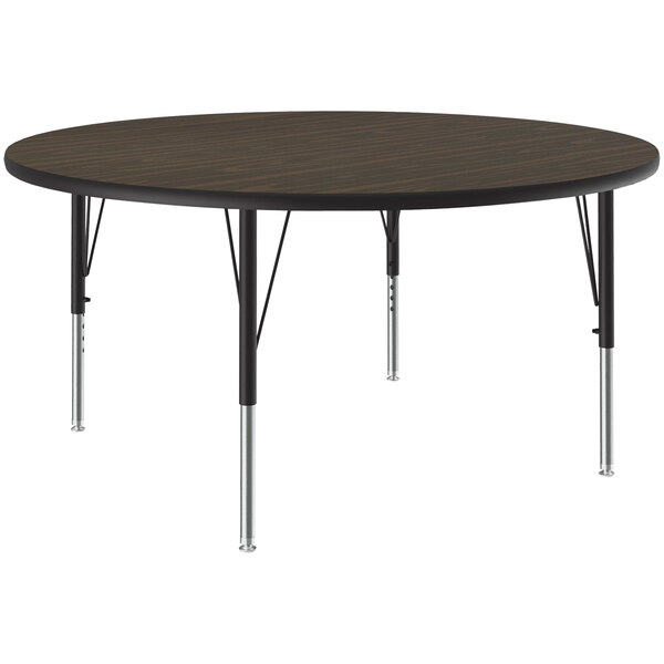 A Correll round activity table with black metal legs and a walnut top.