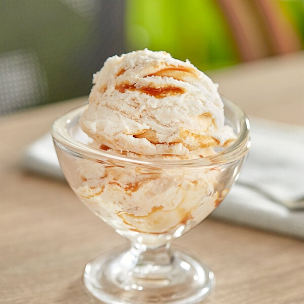A glass dish with a scoop of Oringer Salty Caramel Variegate in it.