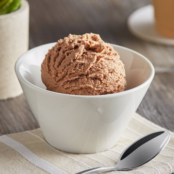 A bowl of brown Oringer Butter Fudge ice cream with a spoon.