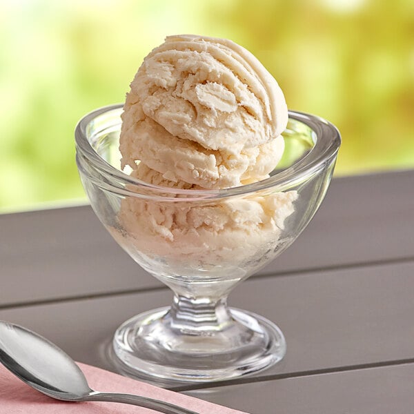 A bowl of Oringer Butter Pecan hard serve ice cream with a spoon on a napkin.