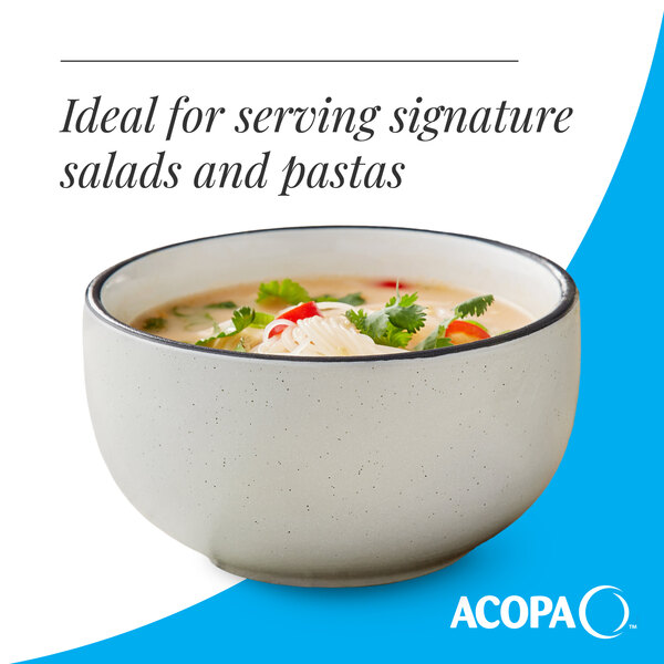 A gray matte stoneware bowl filled with soup, ideal for serving salads and pastas.