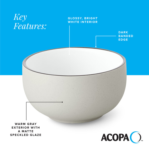 A gray matte stoneware bowl with a glossy white interior and a dark banded edge.