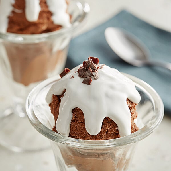 A chocolate ice cream sundae with Oringer marshmallow topping in a glass cup.