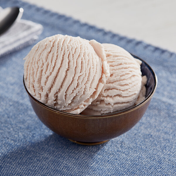 A bowl of Oringer red raspberry hard serve ice cream with a scoop of ice cream in it.