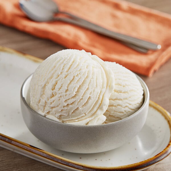 A bowl of Oringer banana hard serve ice cream with a scoop on top.