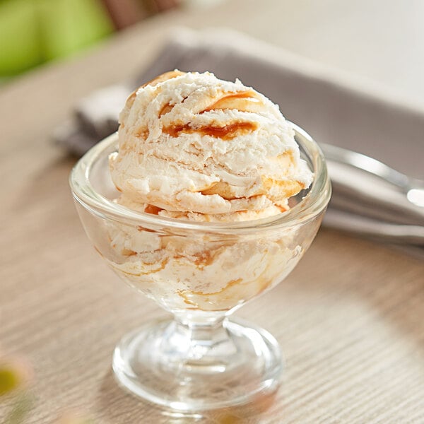 A glass dish of Oringer caramel variegate ice cream with nuts.