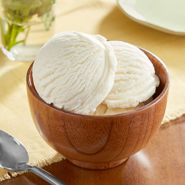 A bowl of Oringer Butter Hard Serve ice cream with a spoon on a table.
