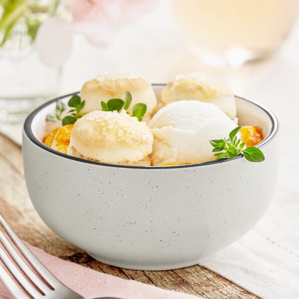 A grey Acopa stoneware bowl filled with ice cream and mint.