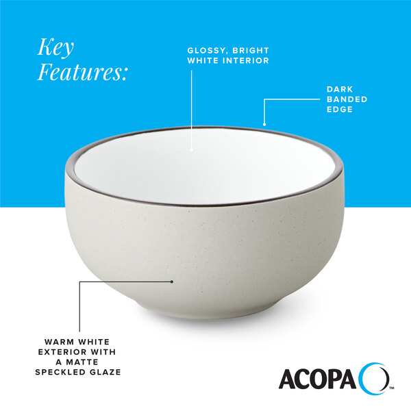 A gray matte stoneware bowl with a glossy white interior, dark banded edge, and speckled glaze.