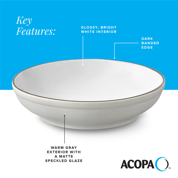 A gray matte stoneware pasta bowl with a glossy white interior and a dark banded edge.