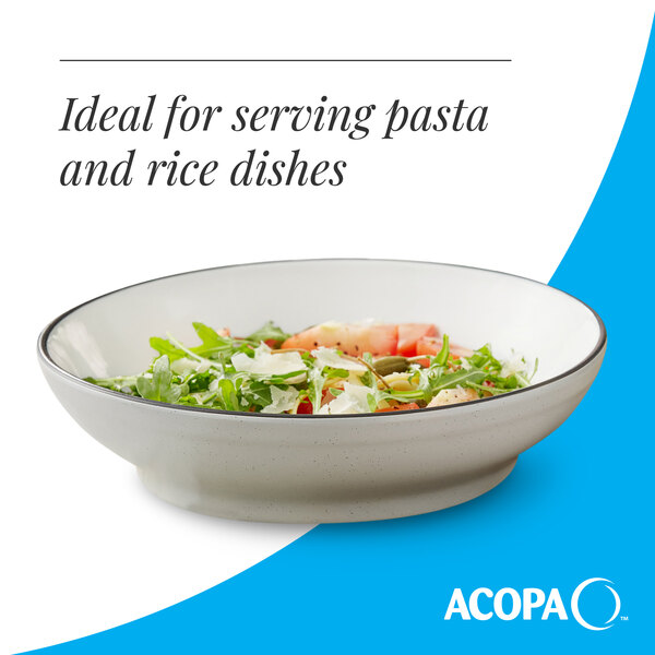 A gray matte stoneware pasta bowl filled with salad.