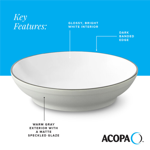 A gray matte stoneware pasta bowl with a glossy white interior and a dark banded edge.