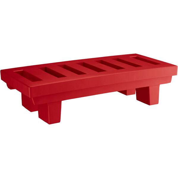 A red plastic bench with slotted top and four legs.