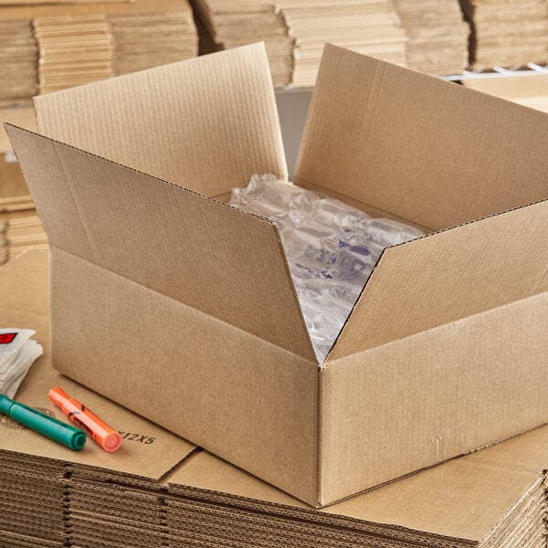 A Lavex Kraft cardboard shipping box wrapped in clear plastic.