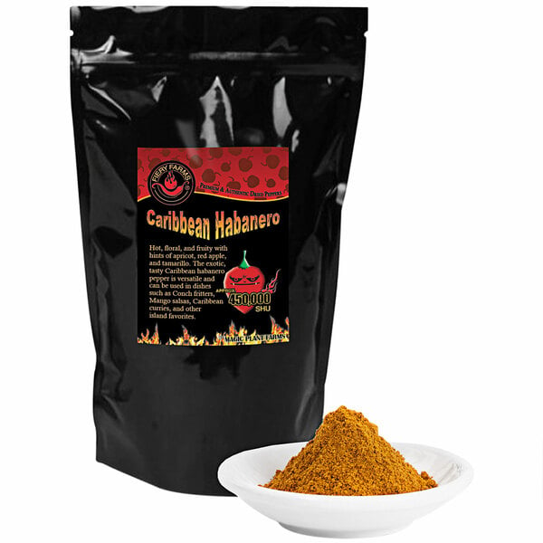 A black bag of Fiery Farms Red Caribbean Habanero Pepper Powder next to a white bowl of yellow powder.