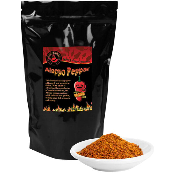 A black bag of Fiery Farms Red Aleppo Pepper Flakes with a white bowl of food.