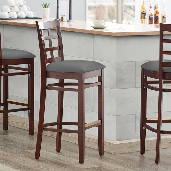 Lancaster Table & Seating Mahogany Finish Wooden Window Back Bar Height Chair with Dark Gray Padded Seat