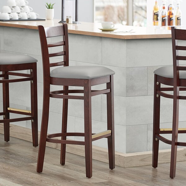 Lancaster Table & Seating Mahogany Finish Wooden Ladder Back Bar Height Chair with Light Gray Padded Seat