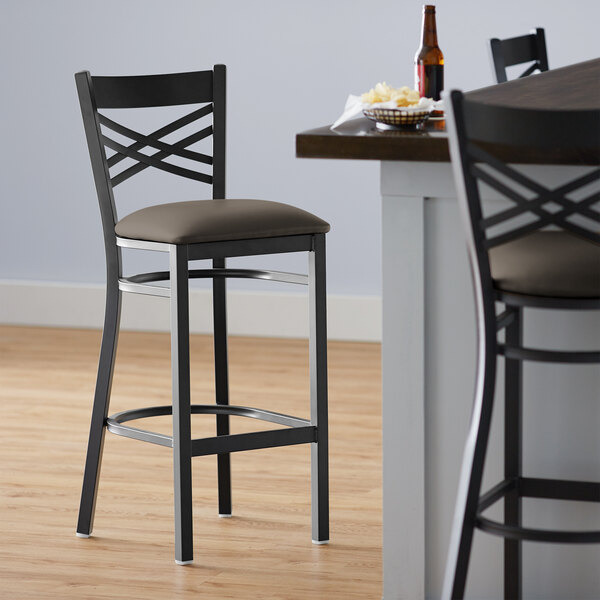 Lancaster Table & Seating Black Finish Cross Back Bar Stool with 2 1/2" Taupe Vinyl Padded Seat
