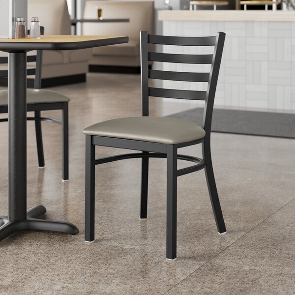 Lancaster Table & Seating Black Finish Ladder Back Chair with 2 1/2" Dark Gray Vinyl Padded Seat