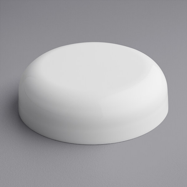 A white round continuous thread lid with a foam liner on a gray surface.