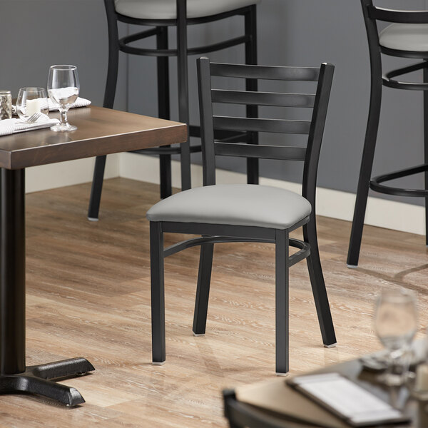Lancaster Table & Seating Black Finish Ladder Back Chair with 2 1/2" Light Gray Vinyl Padded Seat