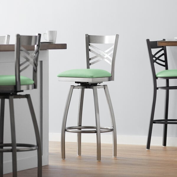 Lancaster Table & Seating Clear Coat Finish Cross Back Swivel Bar Stool with 2 1/2" Seafoam Vinyl Padded Seat