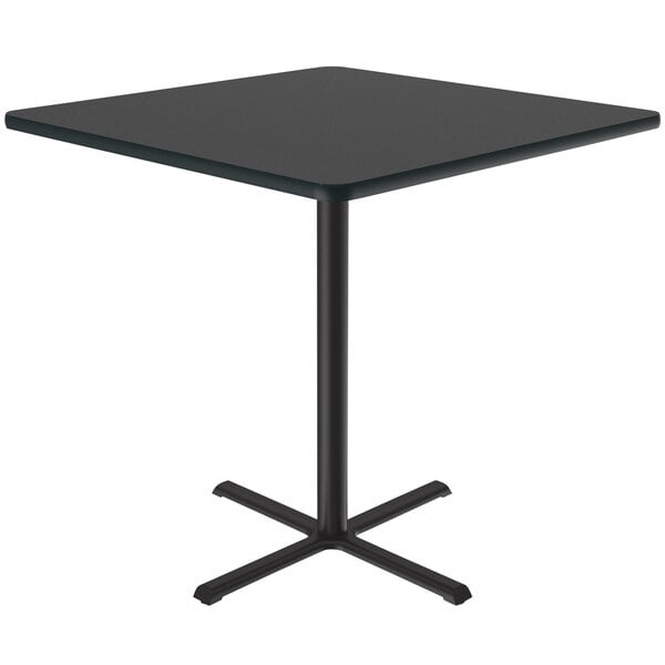 A black square Correll bar height table with a black metal base.