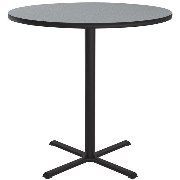 A Correll round gray granite bar height table with a black base.