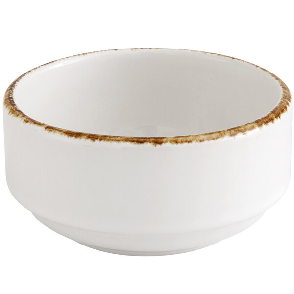 A Fortessa bright white china bowl with a brown rim.