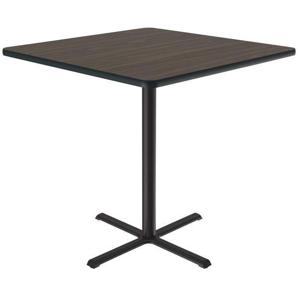 A Correll square table with a black base and brown top.