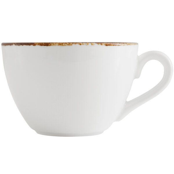 A close up of a Fortessa bright white china cappuccino cup with an earth hue rim.