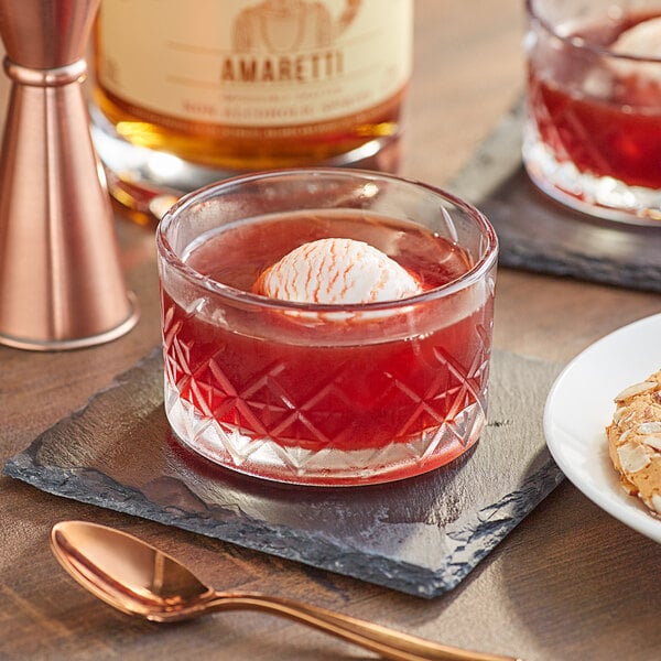 A glass of Lyre's Amaretti non-alcoholic liqueur with a scoop of ice cream in it.