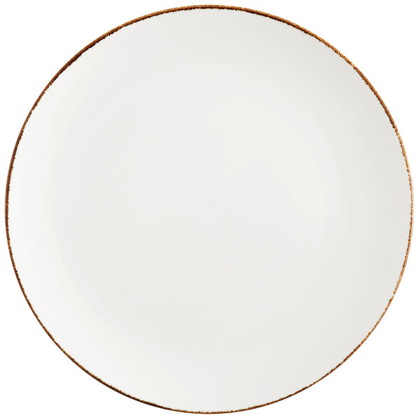 A white Fortessa china coupe plate with a brown rim.