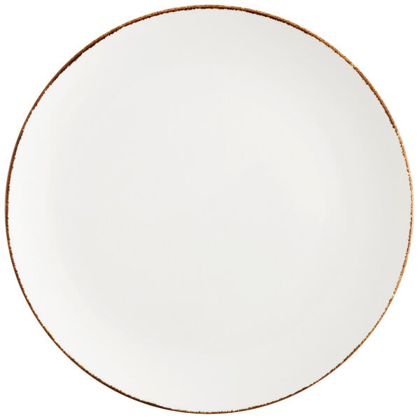 A white Fortessa china coupe plate with a brown rim.