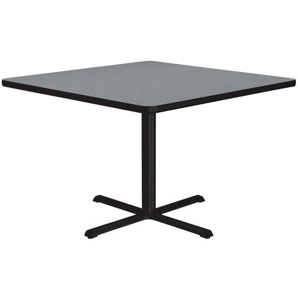 A Correll square table with a gray granite finish top and black base.