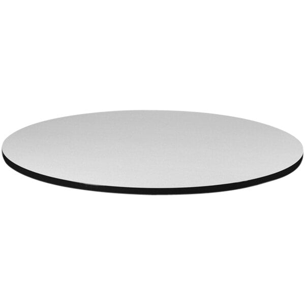 A white circular Correll table top with a black edge.
