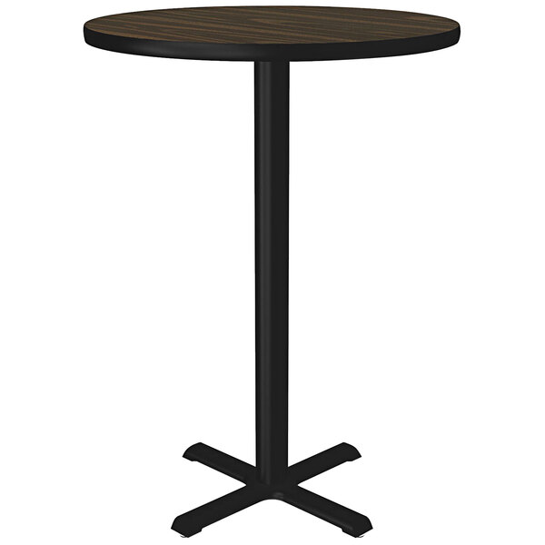 A Correll round walnut laminate bar height table with a black base.