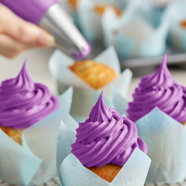 A close-up of a cupcake with purple Rich's Allen Violet Buttrcreme icing.