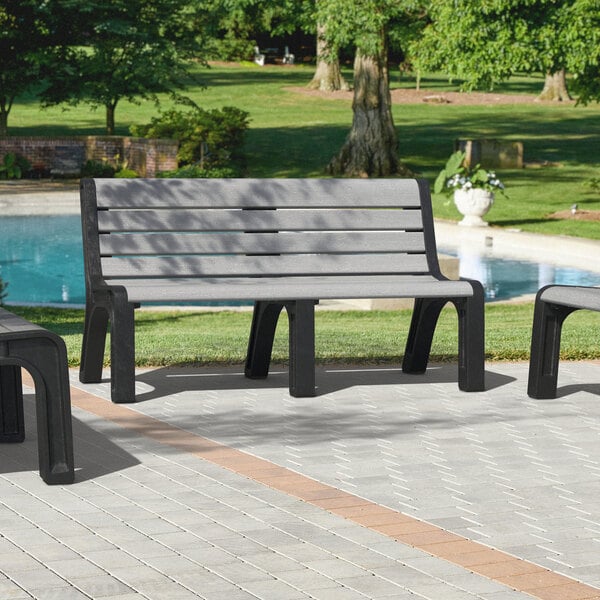 A close-up of a gray MasonWays plastic Malibu-style bench with black legs.