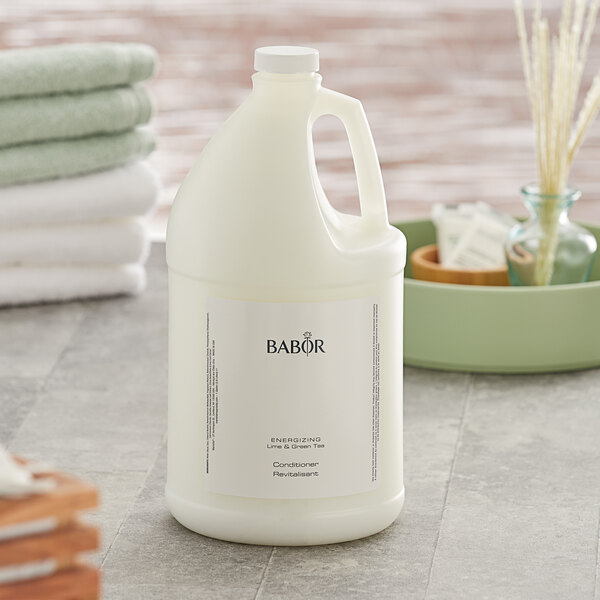 A white jug of Babor Energizing Lime & Green Tea conditioner on a counter.