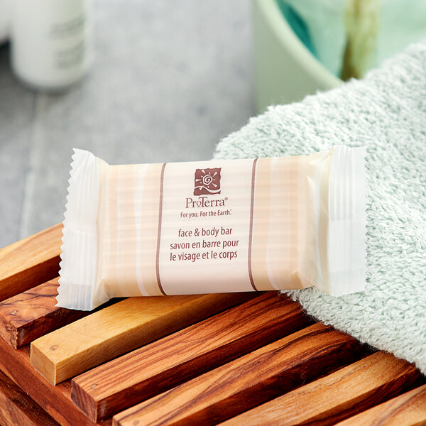 A ProTerra face and body soap bar package on a white towel.