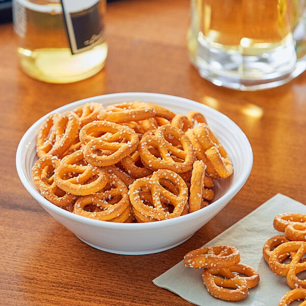 A bowl of Tom Sturgis Little Cheesers pretzels on a table.