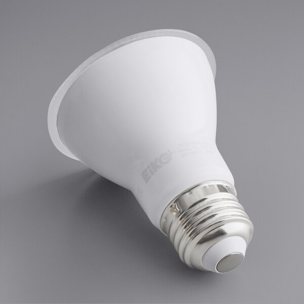 A white Eiko PAR20 LED light bulb with a silver cap on a grey surface.
