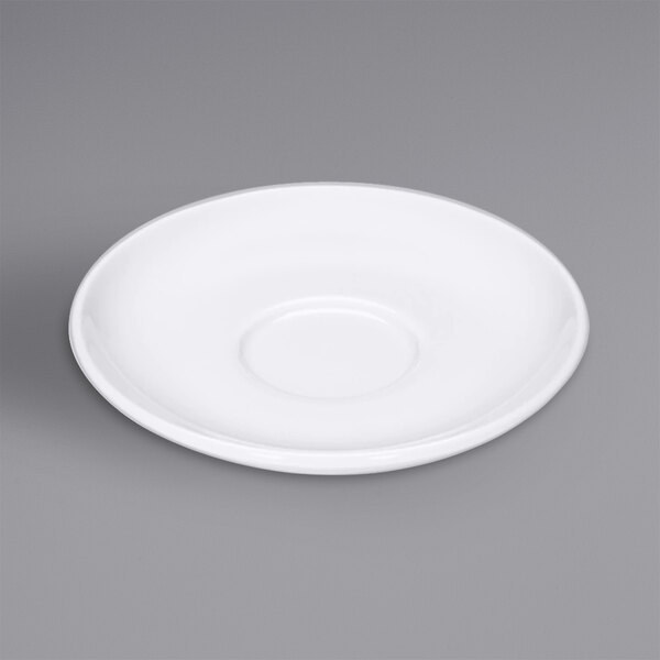 A Bauscher bright white porcelain saucer with a circular edge on a gray surface.