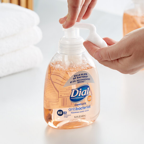 A person using Dial foamy hand soap.